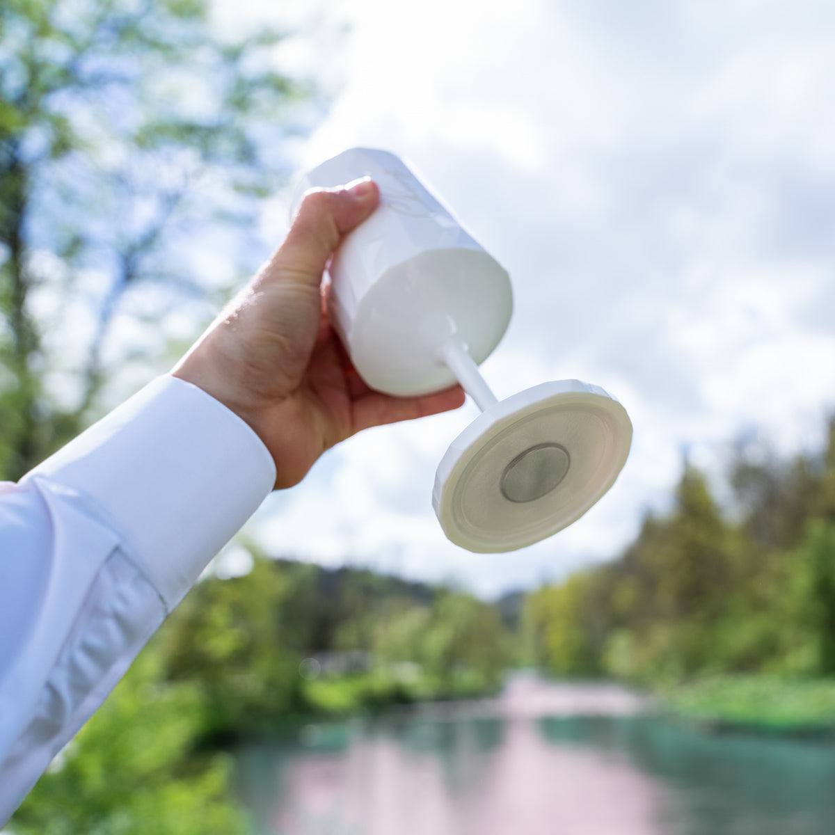 Magnet-Kunststoffglas WEIN Cheers wird in die Luft gehalten