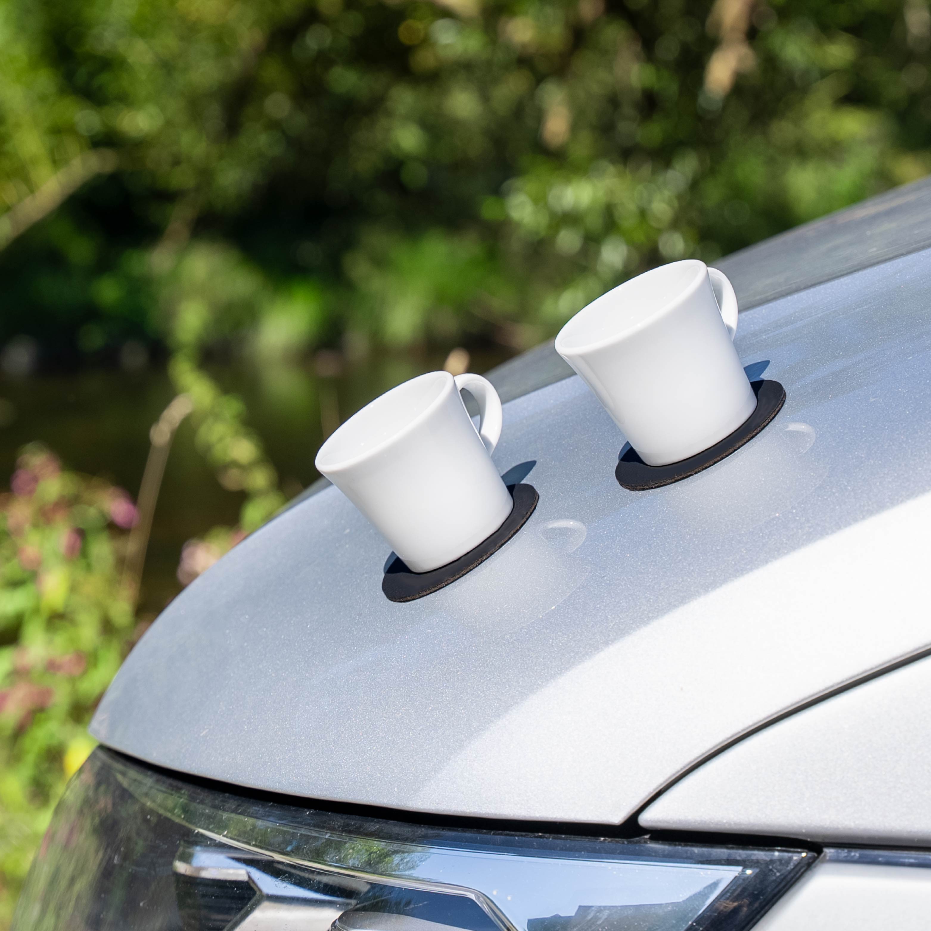 Magnetische Espressotassen aus Porzellan werden durch metallische Motorhaube fixiert